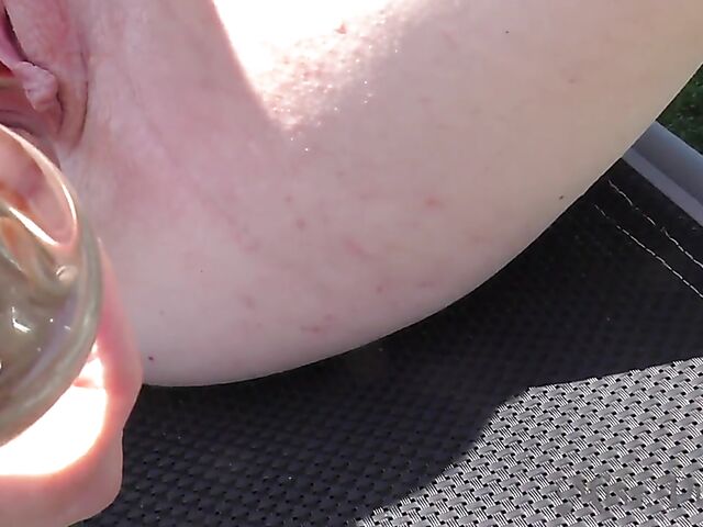 Blonde with glasses Mia shows off her nude body in the hot tub and takes her glass dildo