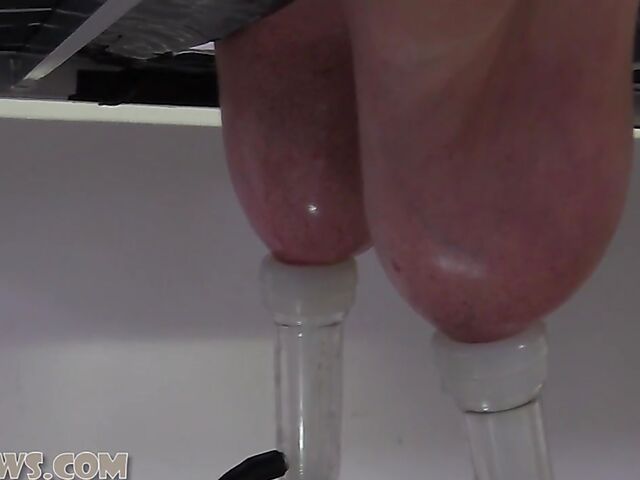 Ball gagged big breasted mature slave Manuela face down on the milking table