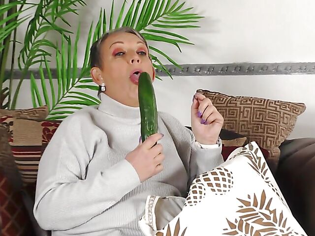 Short hair mature Marika fucks herself with a cucumber