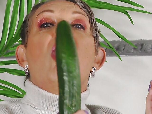 Short hair mature Marika fucks herself with a cucumber