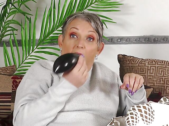 Short hair mature Marika fucks herself with a cucumber