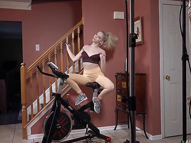 Shaved teen babe Lily Larimar spreading pussy on exercise bike