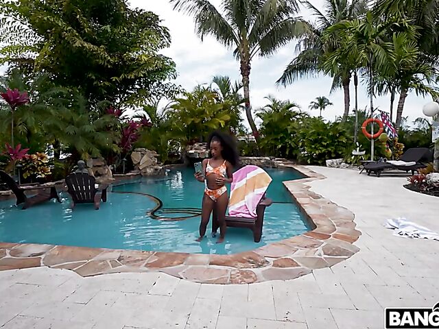 Petite ebony Mini Stallion takes a big black cock by the pool