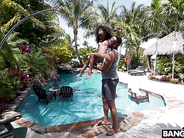 Petite ebony Mini Stallion takes a big black cock by the pool
