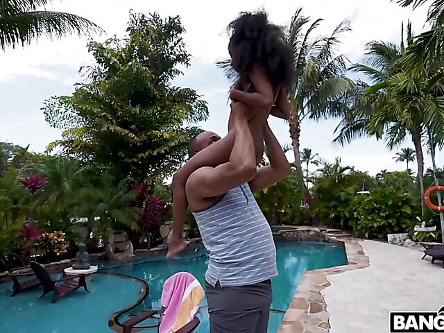 Petite ebony Mini Stallion takes a big black cock by the pool