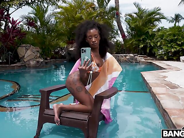 Petite ebony Mini Stallion takes a big black cock by the pool