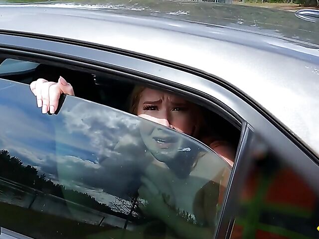 Young redhead Harper Red is naked in the car and needs help