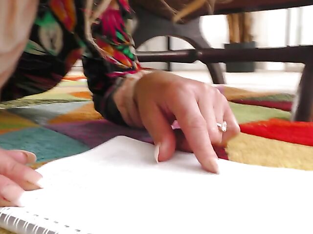 Shaved mature woman with glasses gets naked on the floor and pleasures herself