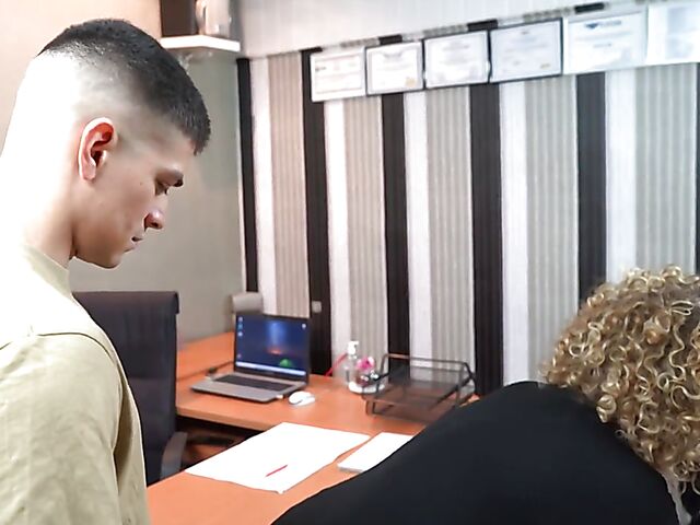 Curly-haired busty MILF boss Merce fucks a young guy at work