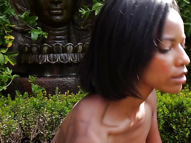 Ebony beauty Luci Lane posing naked in the garden