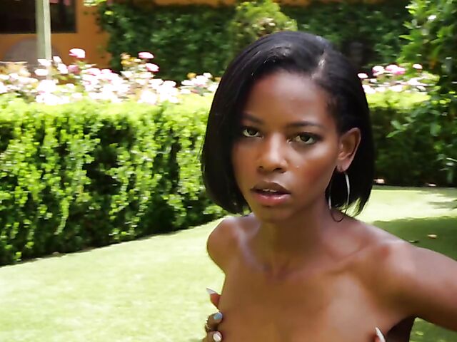 Ebony beauty Luci Lane posing naked in the garden
