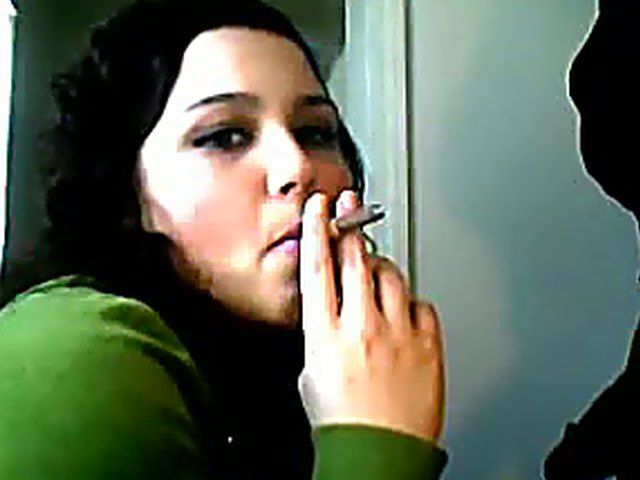Sexy brunette sucks cock whilst smoking a cigarette