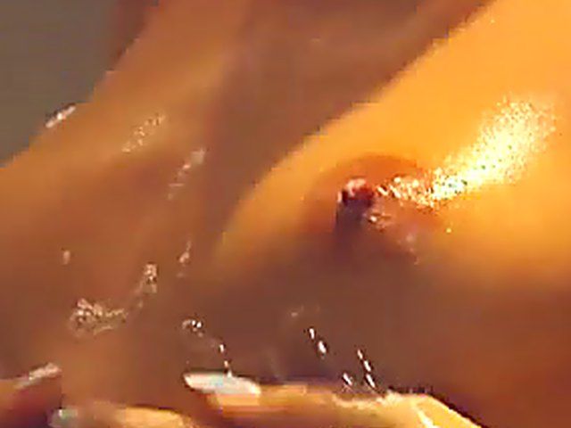 Naughty blonde babe masturbates in the shower