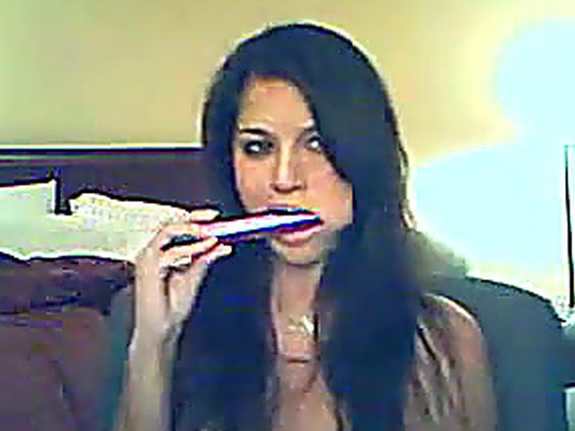 Pretty brunette slides a vibrator into her pussy