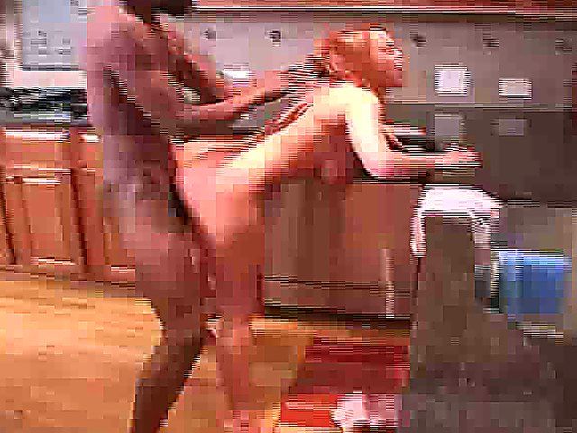 This redhead cooks in the kitchen