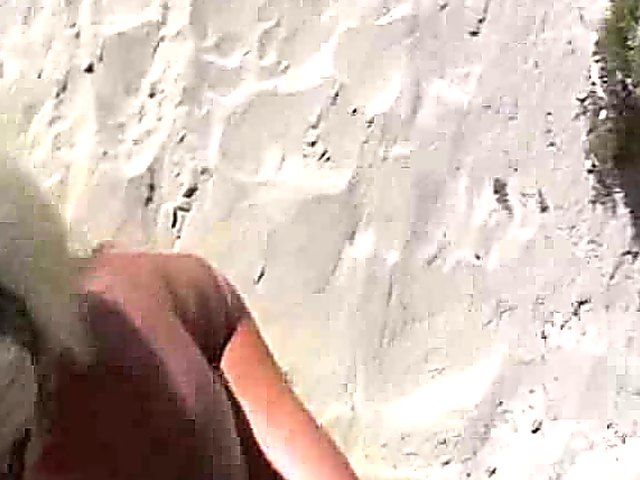 Tanning MILF on beach is exhibitionist