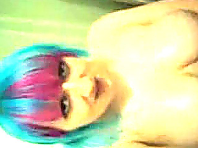 Horny babe oils up her massive pierced breasts