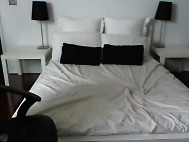 Busty amateur poses naked and sucks a dildo on the bed