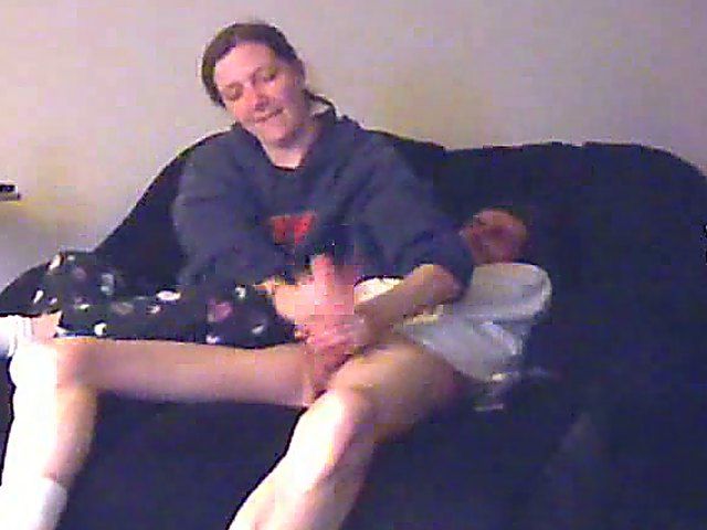 A good looking housewife jerks her husbands cock