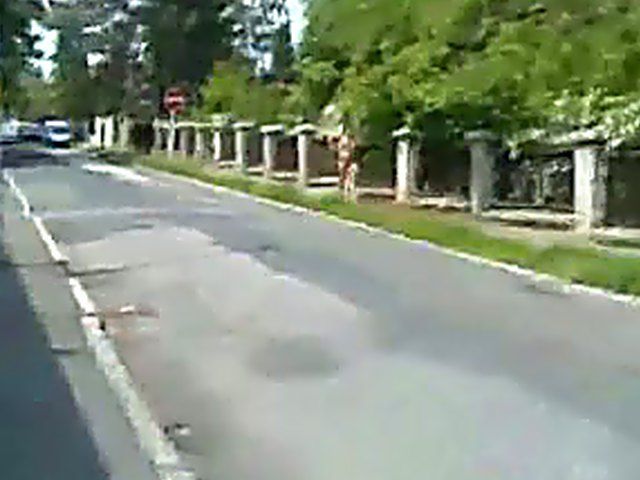 Sexy brunette walks the streets with nothing on