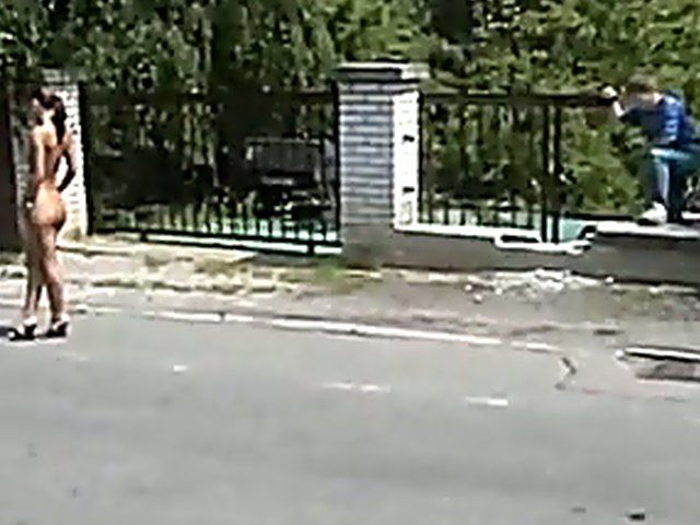 Sexy brunette walks the streets with nothing on