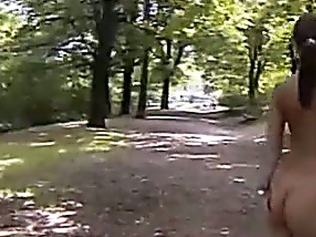 Sexy brunette walks the streets with nothing on