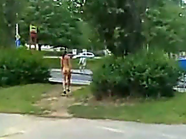 Sexy brunette walks the streets with nothing on