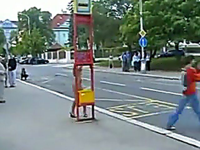 Sexy brunette walks the streets with nothing on