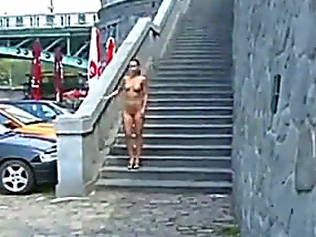 Sexy brunette walks the streets with nothing on