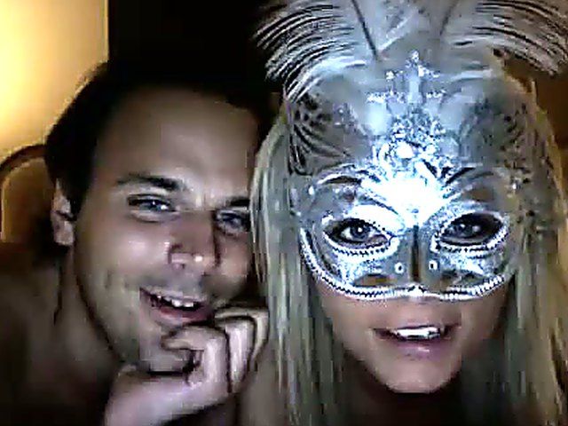 Horny chick wears mask and fingers her holes