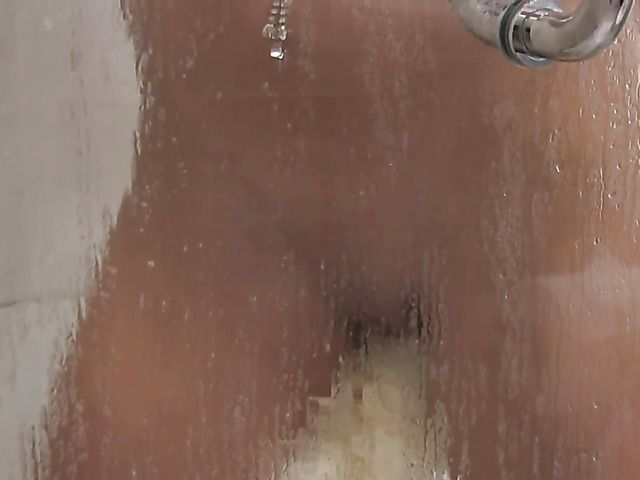 Sexy teen fingers her pussy in the shower