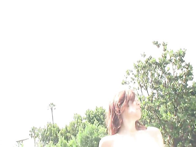 Buxom redhead goes topless