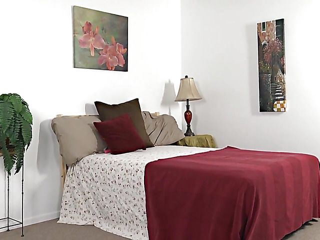 Shaved lesbians with piercing play in the bedroom