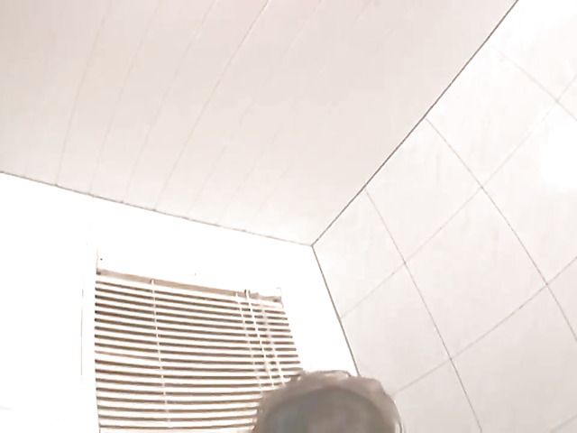 Buxom Japanese wife poses and jerks man off in the bath