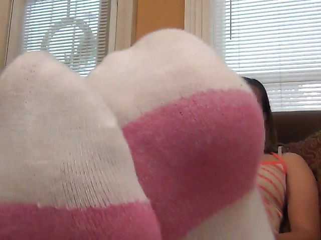 Smoking girl displays her bare soles