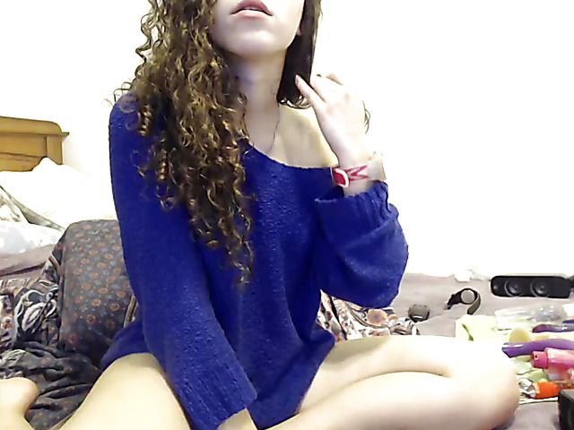 Curly haired girl fucks her holes with vibrator on webcam