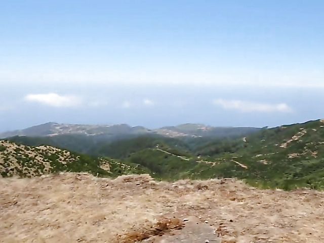 Beautiful leggy brunette strips nude in the mountains