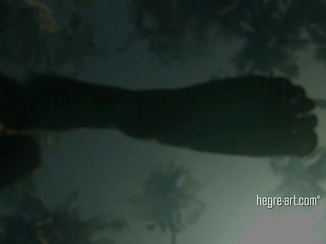 Blonde shows off her wet nude body by the ocean