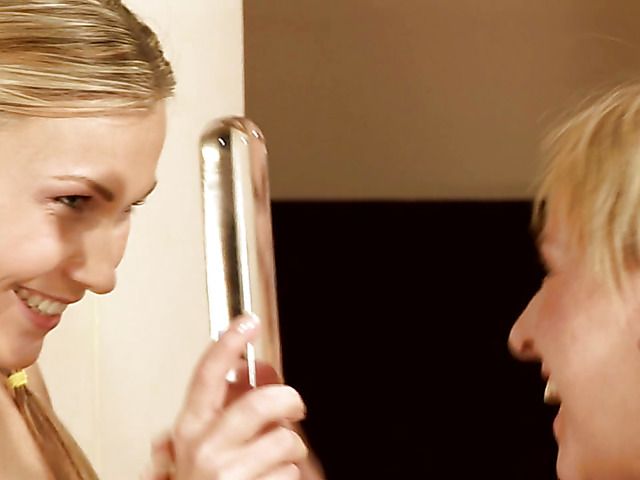 Lesbian teen blondes play with a glass dildo