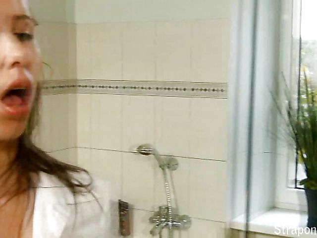 Girl with strap-on jerks off in the tub with her pantyhose on