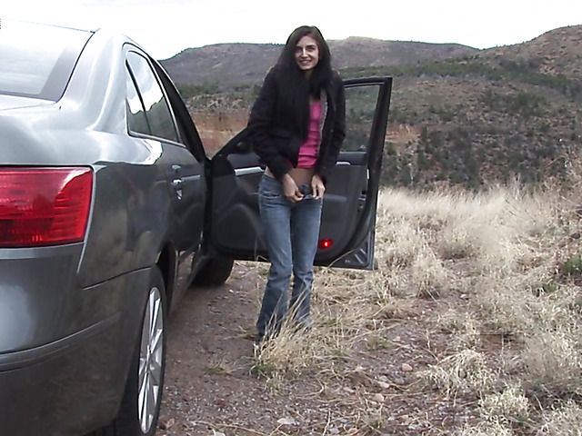 Brunette girl with shaved pussy peeing on the roadside