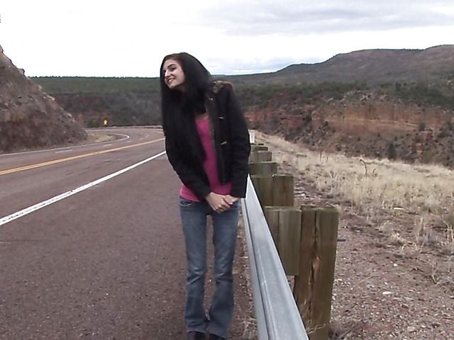 Brunette girl with shaved pussy peeing on the roadside