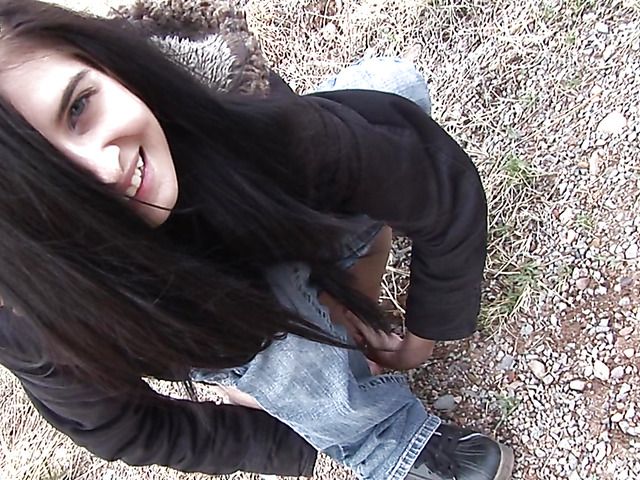 Brunette girl with shaved pussy peeing on the roadside