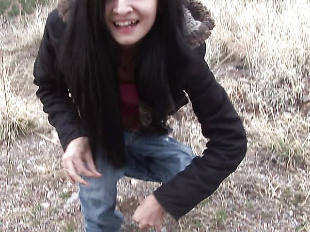 Brunette girl with shaved pussy peeing on the roadside