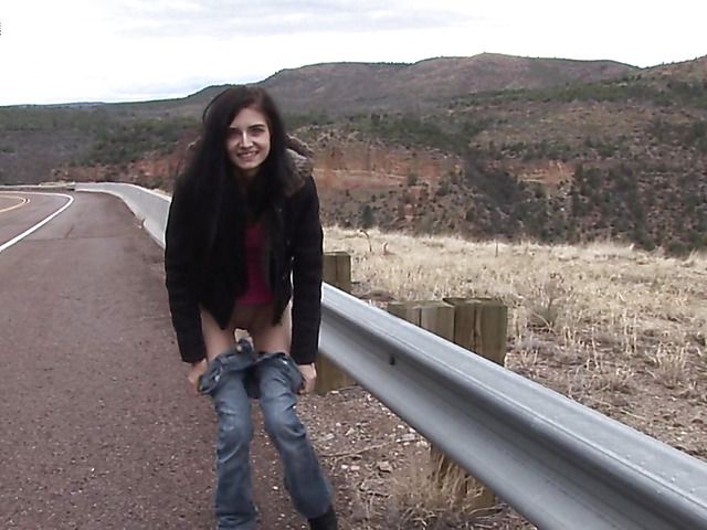 Brunette girl with shaved pussy peeing on the roadside