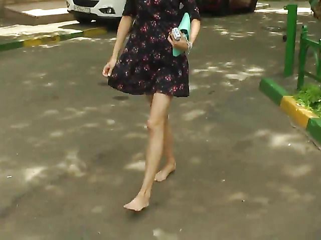 Barefoot amateur with dirty soles in the street