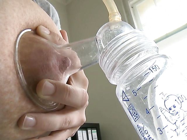 Pretty MILF milks her massive tits in the office