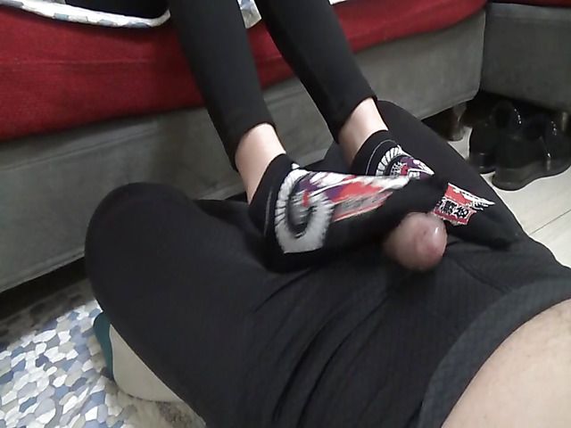 Japanese girl in black socks gives a footjob