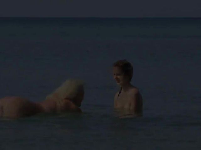 Two playful bikini girls get naked on the beach