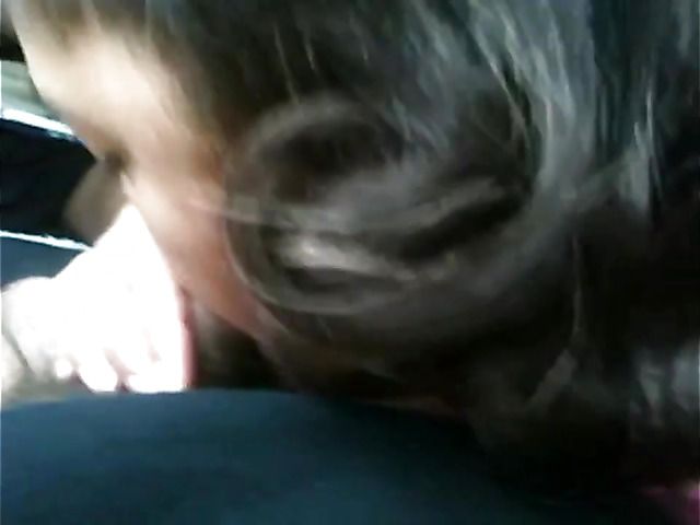 Big breasted amateur giving a car blowjob